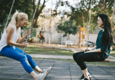 cropped-Women-communicating-with-each-other-on-swings.png